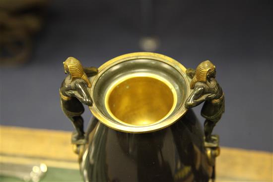 A pair of Egyptian revival patinated bronze urns, 13.25in.